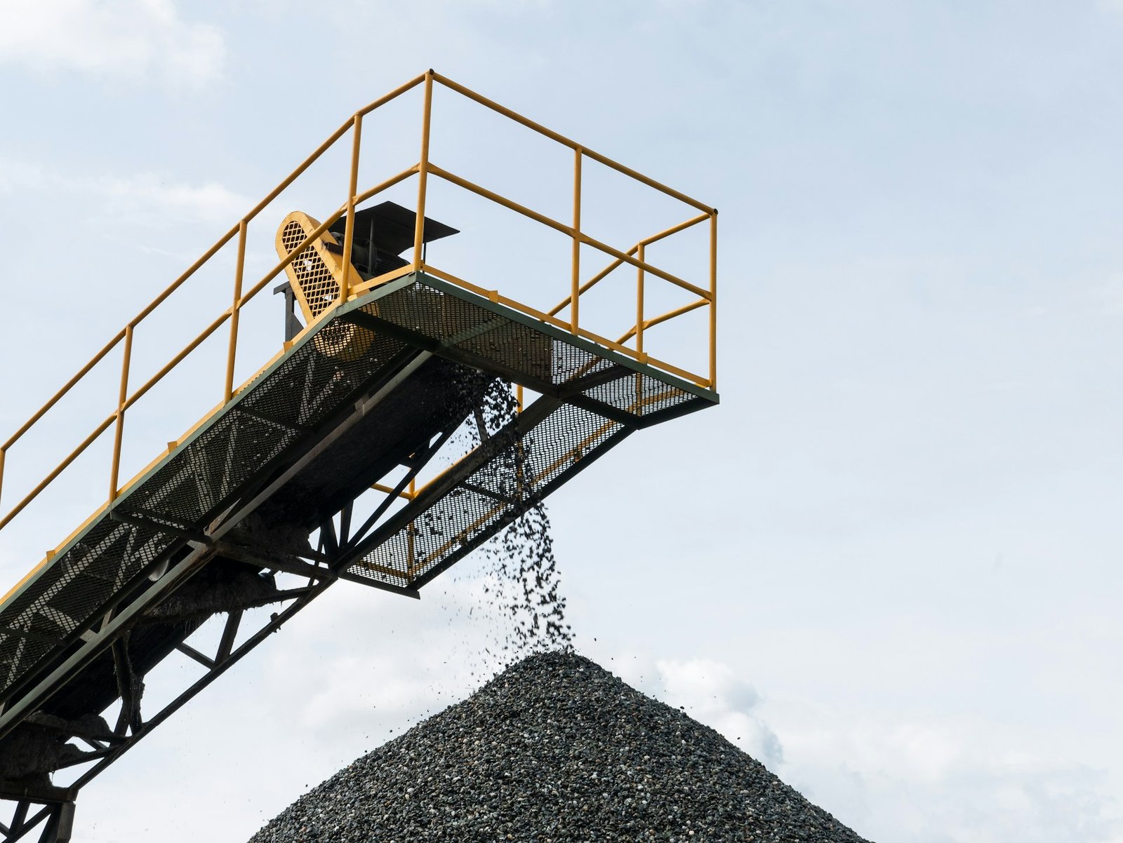 Processed activated carbon discharging from a conveyor onto a stockpile